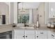 Close up of the kitchen featuring stainless steel appliances, light quartz countertops, and black fixtures at 2772 Golf Lake Dr # 03, Plant City, FL 33566