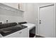 Convenient laundry room with modern washer and dryer units, and playful decor at 2772 Golf Lake Dr # 03, Plant City, FL 33566