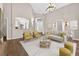 Bright living room featuring vaulted ceilings, wood floors, and views to the kitchen and the front entry at 2772 Golf Lake Dr # 03, Plant City, FL 33566