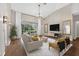 Bright living room with wood floors, vaulted ceiling, sliding glass door to patio, and modern furniture at 2772 Golf Lake Dr # 03, Plant City, FL 33566