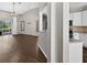 Open concept living room featuring wood floors, arched entryways, and a view of the kitchen at 2772 Golf Lake Dr # 03, Plant City, FL 33566