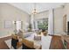 Bright and airy living room with wood floors, vaulted ceiling, and large sliding doors to a patio at 2772 Golf Lake Dr # 03, Plant City, FL 33566