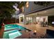 Inviting backyard with a pool, spa, and covered patio with a summer kitchen at 2803 W Aquilla St, Tampa, FL 33629