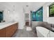 Modern bathroom featuring double vanity, soaking tub, tiled shower and natural light at 2803 W Aquilla St, Tampa, FL 33629
