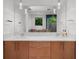 Bathroom featuring modern double vanity with marble countertops, undermount sinks, and stylish fixtures at 2803 W Aquilla St, Tampa, FL 33629