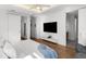 Bedroom features a ceiling fan, flatscreen television, hardwood floors, ensuite bathroom, and ample closet space at 2803 W Aquilla St, Tampa, FL 33629