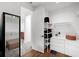 Walk-in closet with hardwood floors, white shelving, drawers, and a full length mirror at 2803 W Aquilla St, Tampa, FL 33629