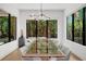 Bright dining room with large windows, a glass table, and modern lighting fixtures at 2803 W Aquilla St, Tampa, FL 33629