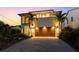 Modern two-story home with lush landscaping and a brick paver driveway at dusk at 2803 W Aquilla St, Tampa, FL 33629