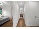 Hallway with hardwood floors leading to a bedroom at 2803 W Aquilla St, Tampa, FL 33629