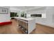 Modern kitchen featuring a large island with bar seating, sleek white cabinetry, and top-of-the-line appliances at 2803 W Aquilla St, Tampa, FL 33629