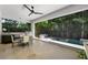 Inviting outdoor living space with a summer kitchen, dining area, and serene pool at 2803 W Aquilla St, Tampa, FL 33629