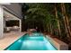 Inviting pool with jacuzzi, outdoor kitchen, and seating surrounded by lush tropical landscaping at 2803 W Aquilla St, Tampa, FL 33629