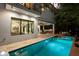 Rear exterior view showcasing the pool, spa, patio dining, outdoor kitchen, and covered lanai at 2803 W Aquilla St, Tampa, FL 33629