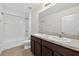 Bathroom with double sinks, granite counters, and a tub with shower at 3125 S Northview Rd, Plant City, FL 33566