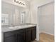 Bathroom featuring a double sink vanity, framed mirror, and walk in closet with wire shelving at 3125 S Northview Rd, Plant City, FL 33566