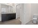 Bright bathroom featuring a double sink vanity, framed mirror, toilet and closet at 3125 S Northview Rd, Plant City, FL 33566