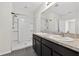 Bathroom featuring a double sink vanity, framed mirror, and tile flooring adjacent to a shower at 3125 S Northview Rd, Plant City, FL 33566