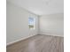 Bright bedroom featuring wood-look flooring and a window for natural light at 3125 S Northview Rd, Plant City, FL 33566
