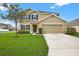 Inviting two-story home featuring a manicured lawn and a neutral-toned facade at 3125 S Northview Rd, Plant City, FL 33566