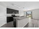 Modern kitchen featuring black cabinets, an island, and sliding glass doors at 3125 S Northview Rd, Plant City, FL 33566