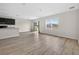 Open-concept living space featuring modern floors, an island, and a patio door at 3125 S Northview Rd, Plant City, FL 33566