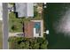Aerial view of canal-front home with screened pool and private boat dock at 3243 Azalea Dr, Hernando Beach, FL 34607