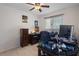 Bright bedroom featuring a ceiling fan, neutral walls, tiled floor and an organized desk perfect for a cozy and practical retreat at 3243 Azalea Dr, Hernando Beach, FL 34607