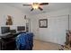 Bright bedroom with neutral walls, tiled floor, a ceiling fan, and ample storage space perfect for a cozy and functional retreat at 3243 Azalea Dr, Hernando Beach, FL 34607