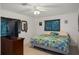 Comfortable bedroom with ceiling fan, mirror, and stylish curtains creates a serene retreat at 3243 Azalea Dr, Hernando Beach, FL 34607