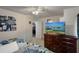 Bright bedroom with ceiling fan, dark dresser, and TV provides a cozy and functional space at 3243 Azalea Dr, Hernando Beach, FL 34607