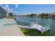 A dock in the water with an easy access ramp and bench for relaxing by the water at 3243 Azalea Dr, Hernando Beach, FL 34607