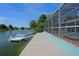 View of the dock and patio by the water, as well as pool access on the screen enclosed patio at 3243 Azalea Dr, Hernando Beach, FL 34607
