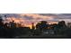 Exterior view of the property with a vibrant sunset in the background at 3243 Azalea Dr, Hernando Beach, FL 34607