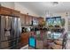 Well-equipped kitchen with stainless steel appliances, dark wood cabinets, granite countertops, and a functional island at 3243 Azalea Dr, Hernando Beach, FL 34607