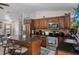 Spacious kitchen with stainless steel appliances, dark wood cabinets, granite counters, and a stylish island at 3243 Azalea Dr, Hernando Beach, FL 34607