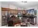 Modern kitchen featuring stainless steel appliances, dark wood cabinets, a central island, and bright pendant lighting at 3243 Azalea Dr, Hernando Beach, FL 34607