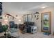 Cozy living room with comfortable seating, tile floors, decor and a stylish front door with decorative glass at 3243 Azalea Dr, Hernando Beach, FL 34607