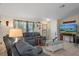 Relaxing living area featuring plush sofas, tile flooring, decorative accents, and a view of the exterior at 3243 Azalea Dr, Hernando Beach, FL 34607