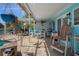 Enclosed patio with brick flooring, comfortable seating, ceiling fan, and outdoor cooking area at 3243 Azalea Dr, Hernando Beach, FL 34607
