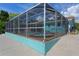 Enclosed pool area with above ground hot tub and access to outdoor kitchen at 3243 Azalea Dr, Hernando Beach, FL 34607