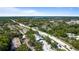 Scenic aerial view displays a community and features lush landscapes and paved roads at 3350 Fox Hunt Dr, Palm Harbor, FL 34683