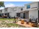 Townhouse backyard features a patio with grill and outdoor furniture with screened in back porch at 3350 Fox Hunt Dr, Palm Harbor, FL 34683