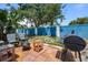 Outdoor patio features a grill, chairs and a vibrant blue fence at 3350 Fox Hunt Dr, Palm Harbor, FL 34683