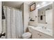 Cozy bathroom features stylish shower curtain, framed wall art, and white fixtures at 3350 Fox Hunt Dr, Palm Harbor, FL 34683