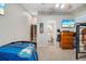 Bedroom view with gaming decor, including flat screen TV and video game art piece at 3350 Fox Hunt Dr, Palm Harbor, FL 34683