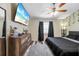 Relaxing bedroom featuring stylish ceiling fan, soft carpet and wall-mounted TV at 3350 Fox Hunt Dr, Palm Harbor, FL 34683