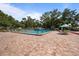 Enjoy this lovely community pool with ample seating and shade trees for a relaxing time at 3350 Fox Hunt Dr, Palm Harbor, FL 34683