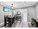 Open-concept dining area with modern table, chairs, and view of the kitchen at 3350 Fox Hunt Dr, Palm Harbor, FL 34683