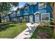 Attractive townhome with manicured garden beds and a paved walkway to the front entrance at 3350 Fox Hunt Dr, Palm Harbor, FL 34683